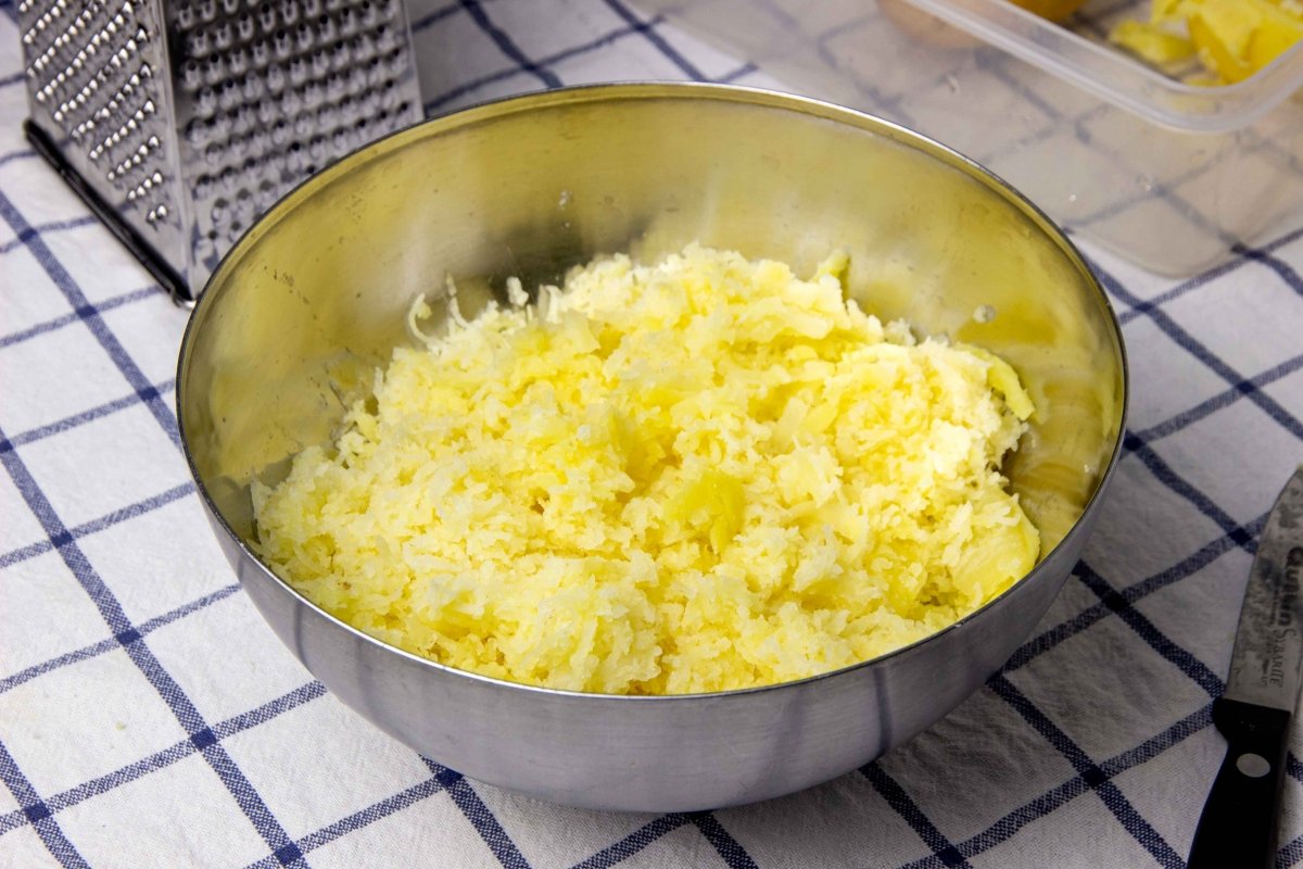 Grate the cooked potatoes into a bowl