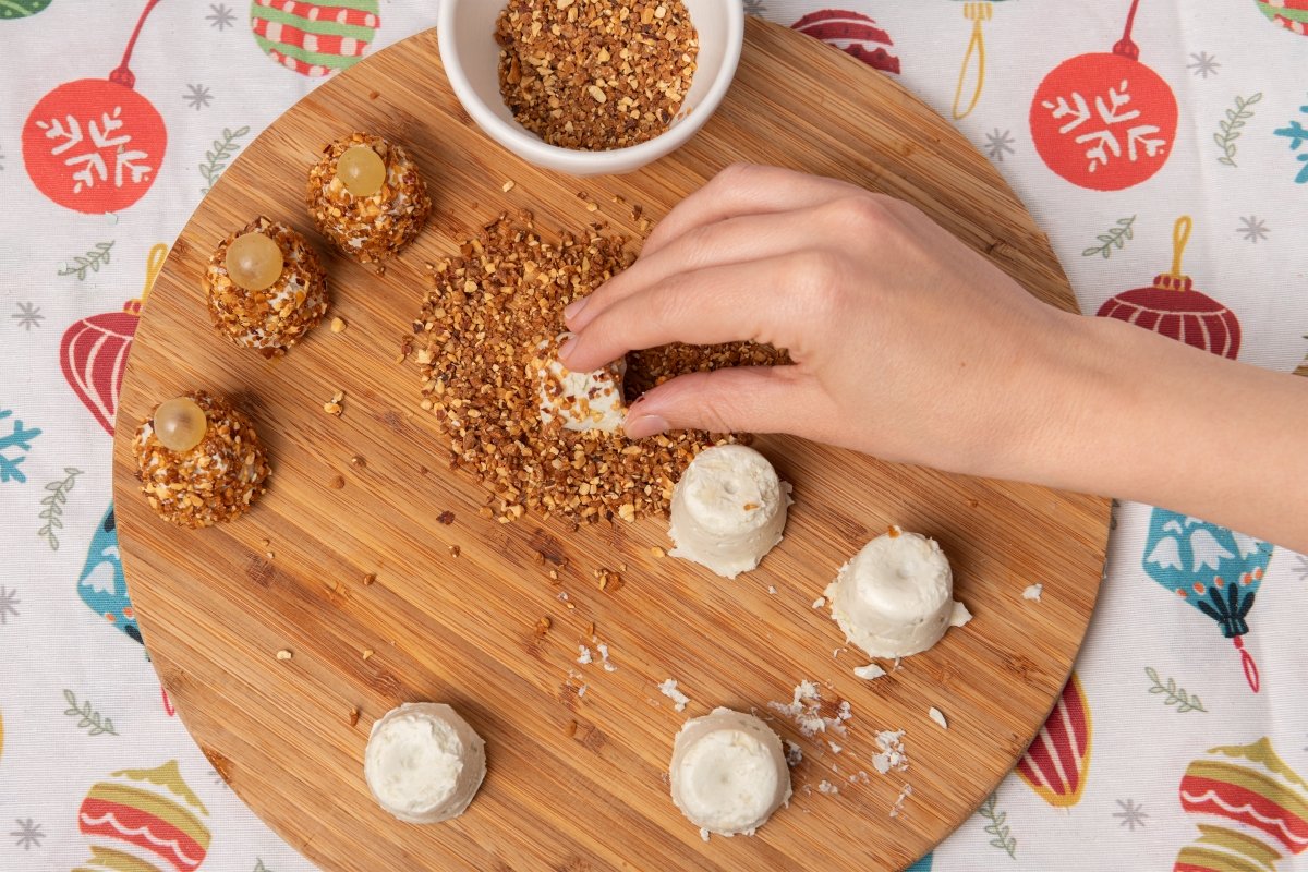 Rebozando los bombones de queso para los canapés de Navidad