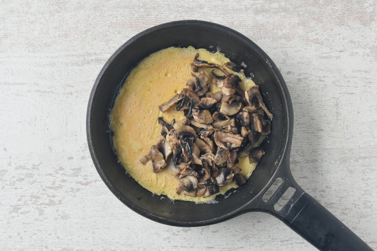 Repartimos los champiñones encima de la tortilla