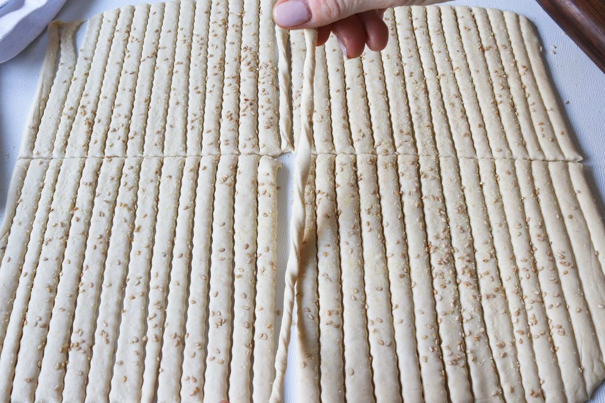Twist the strips of dough for the breadsticks