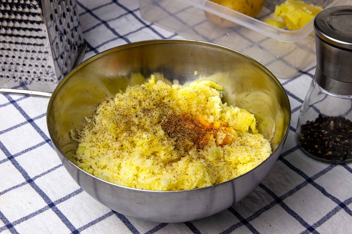 Season the grated potato mixture with salt and pepper