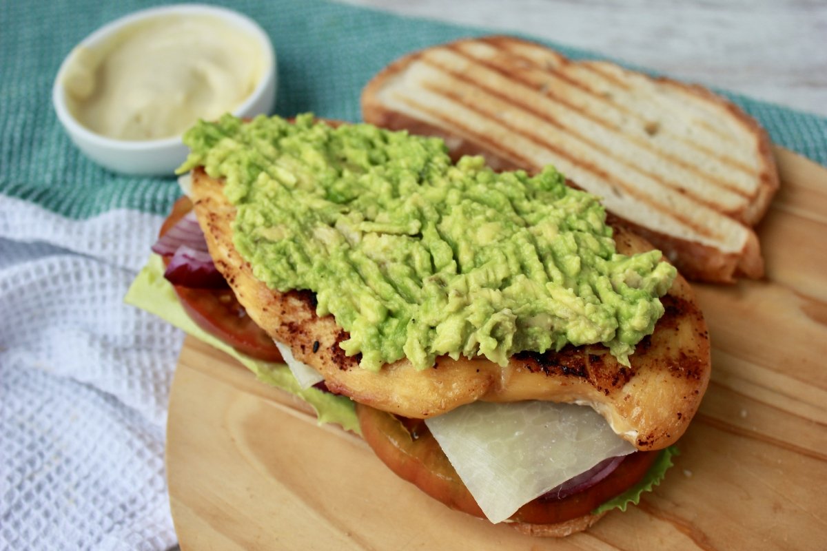Chicken and avocado sandwich being assembled