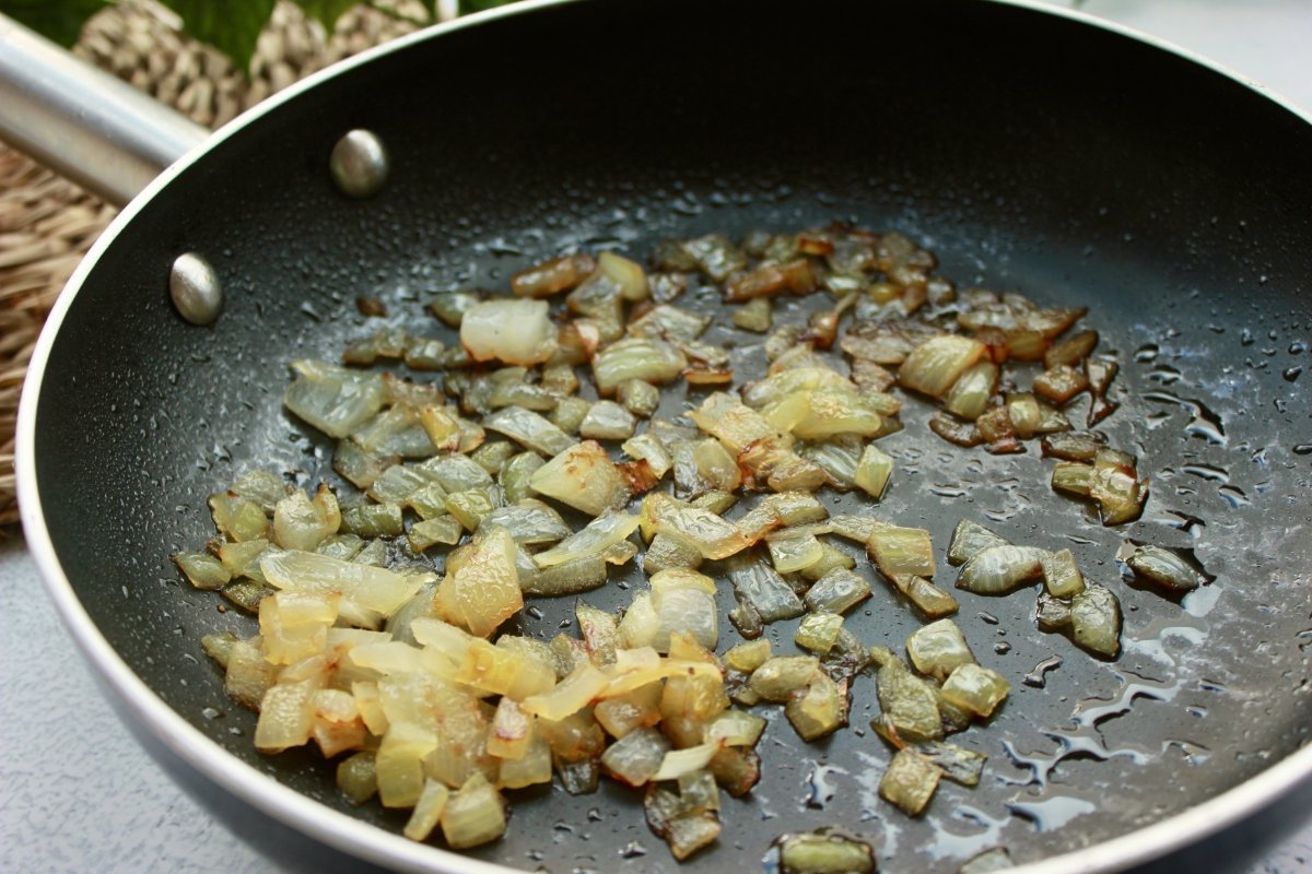 Skillet with diced poached onion