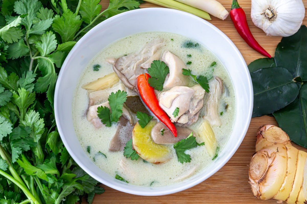 Servir la sopa tom kha kai