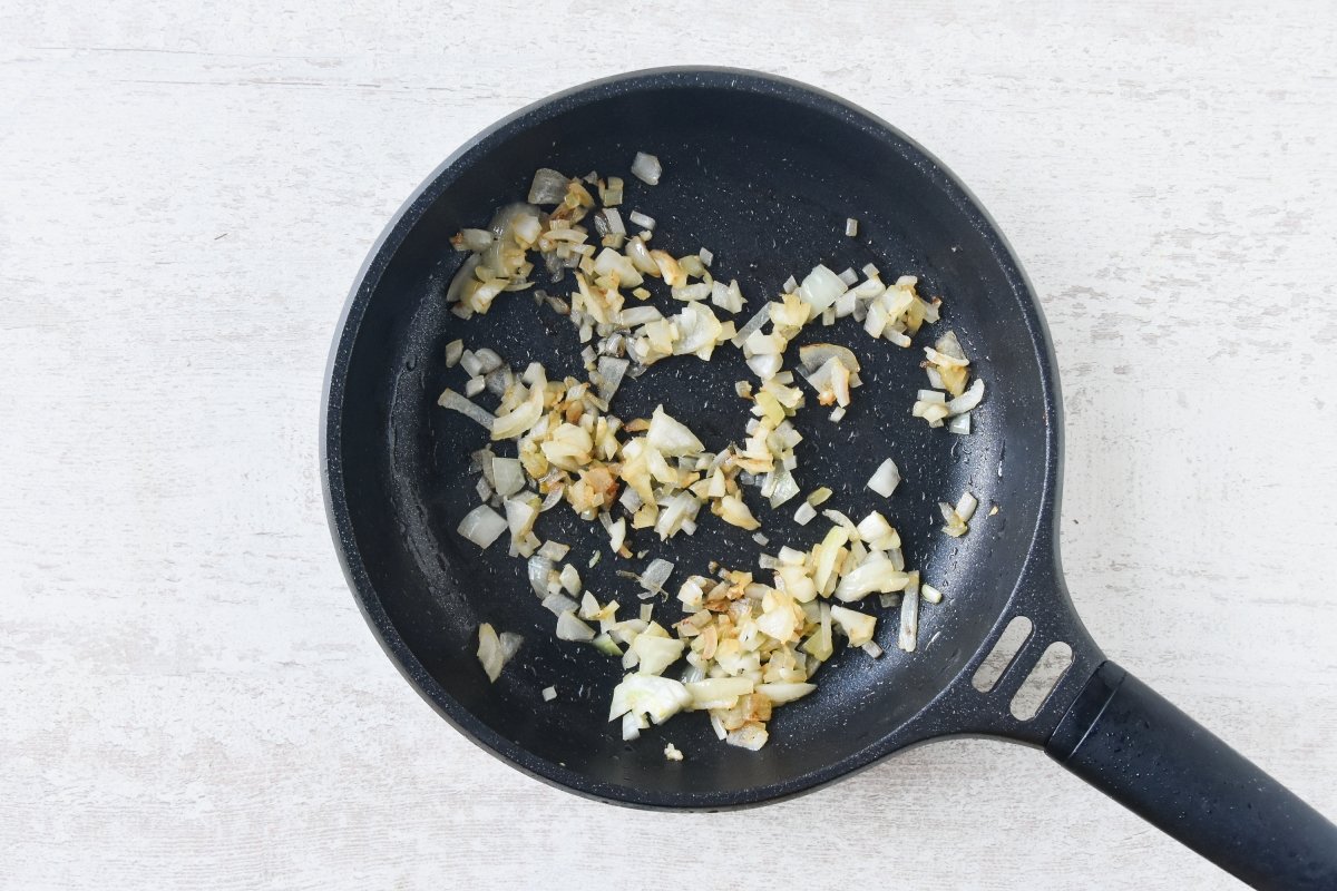Sofreímos la cebolla y el ajo para la salsa de queso