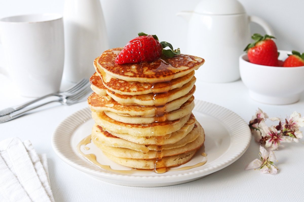 Gluten-free pancakes with strawberry and syrup