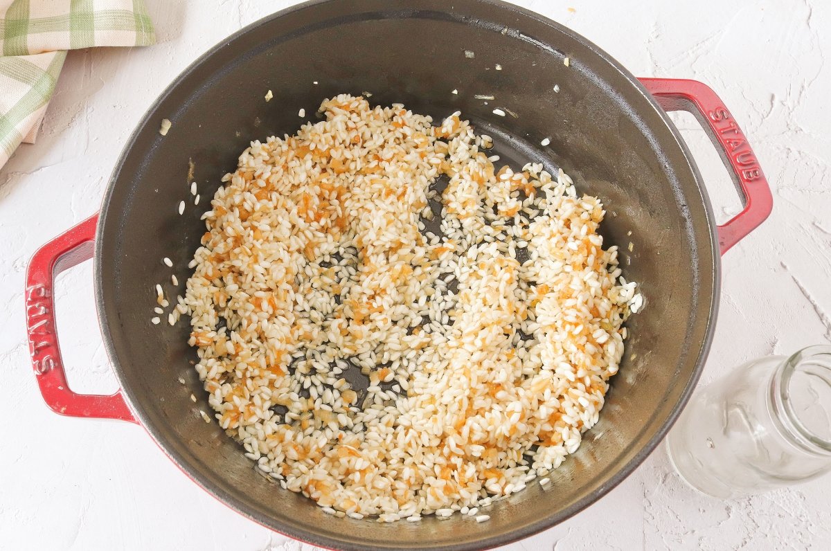 Tostar el arroz y añadir el vino al risotto de espinacas