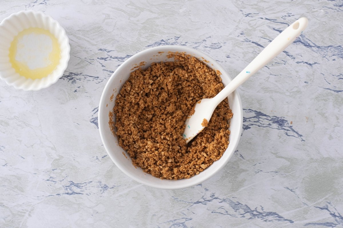 Crush the biscuits with butter and salt