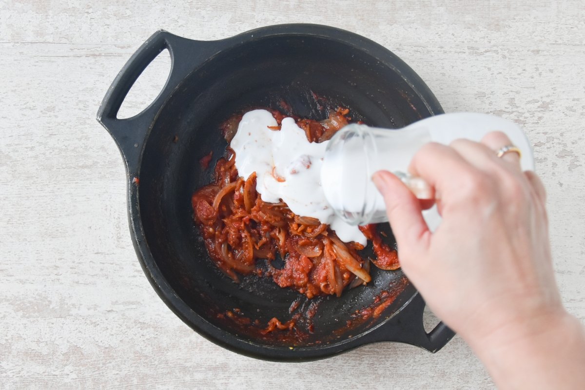 Vertemos la leche de coco sobre la salsa de tomate