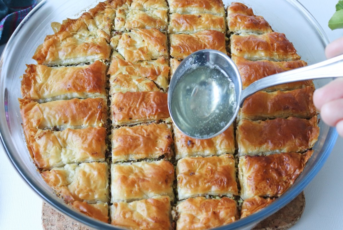 Pour the syrup over the baklava