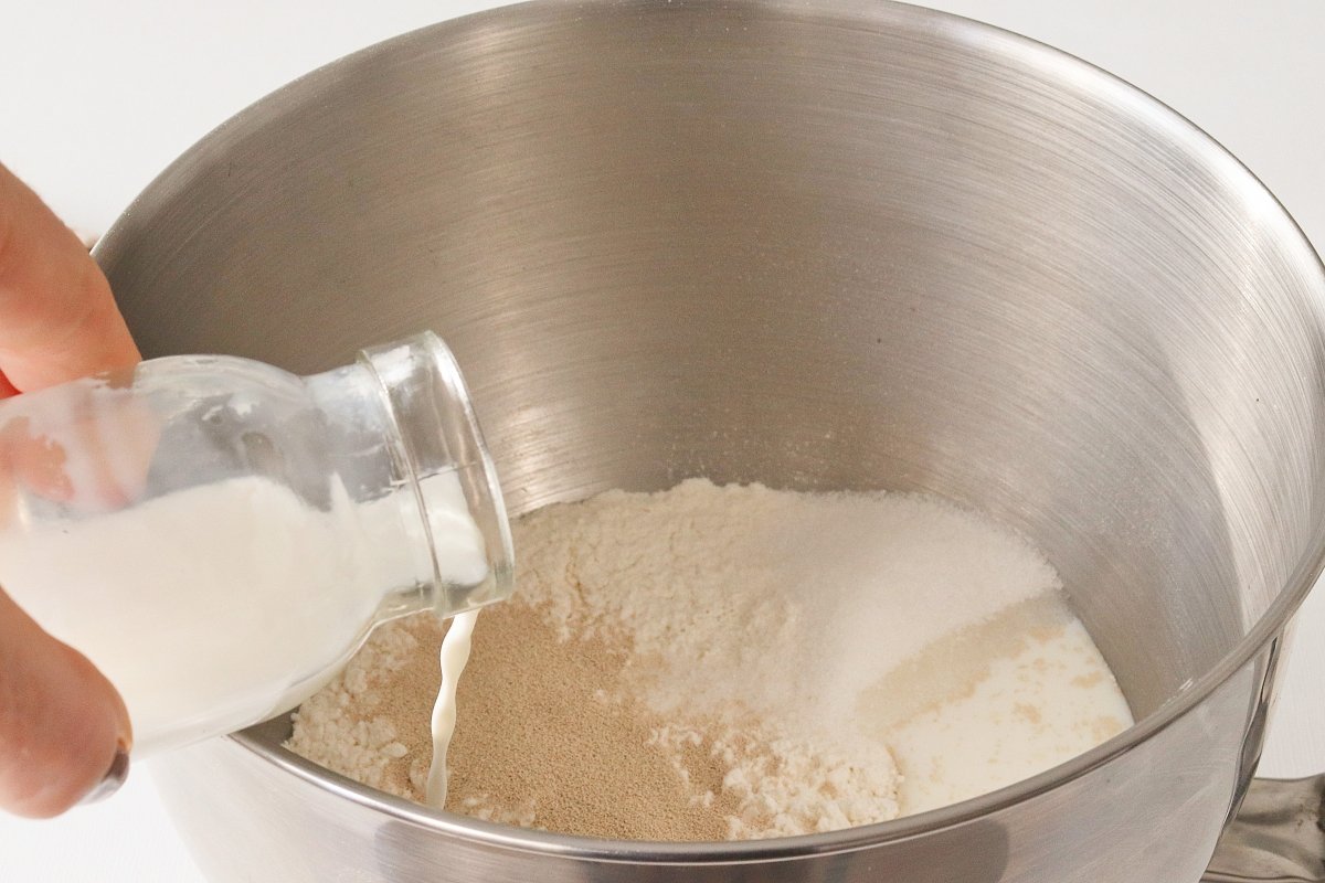 Pour milk into the cinnamon roll dough