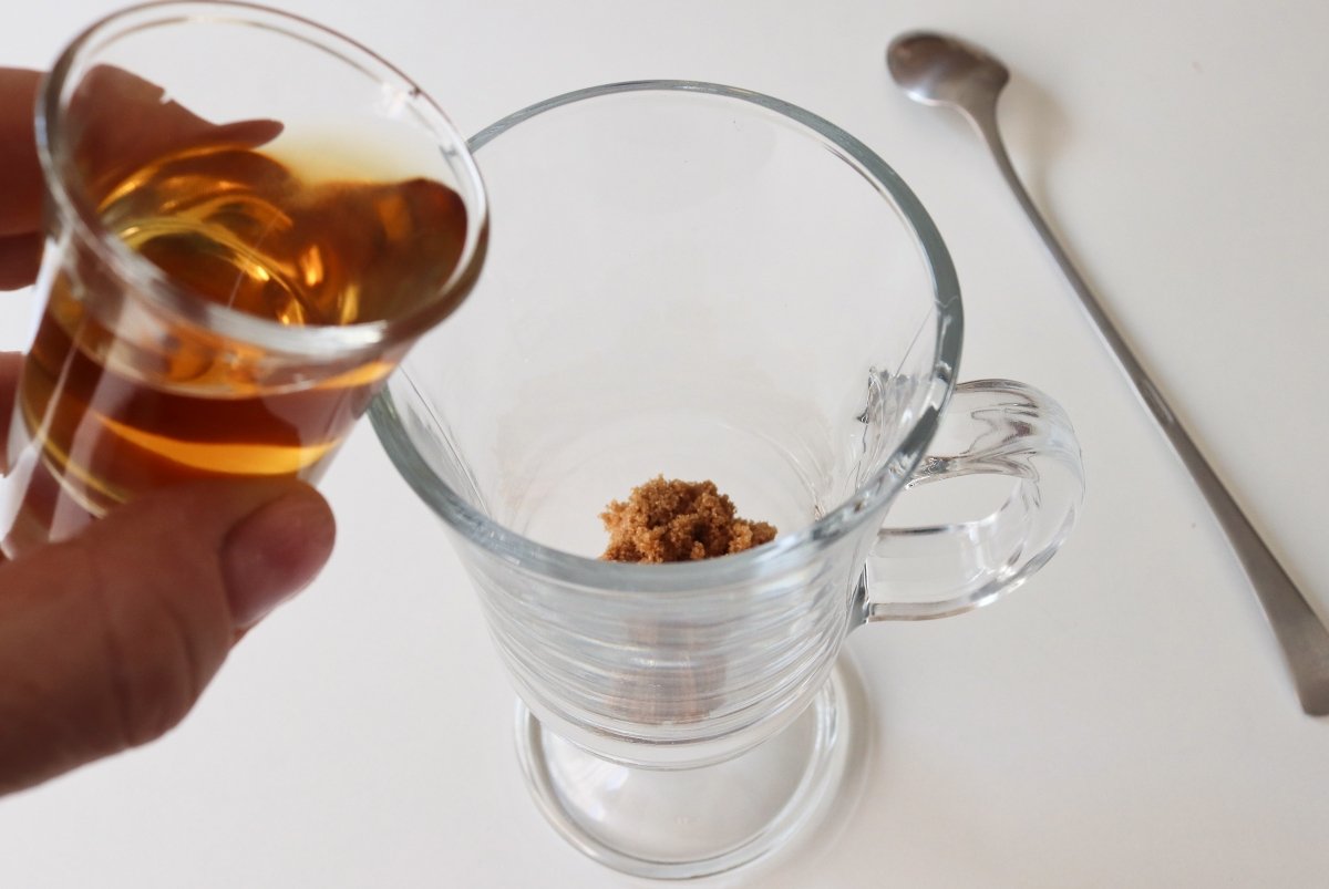 Pouring whiskey irish coffee cocktail